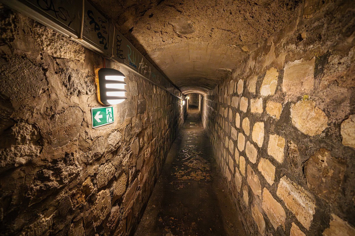 Stone corridor inside the Paris Catacombs